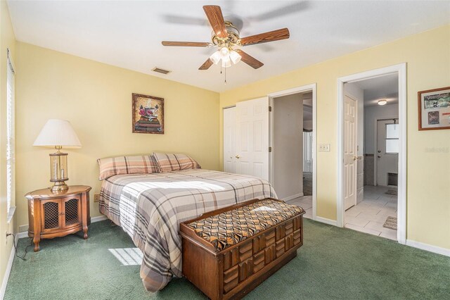 bedroom with carpet floors, a closet, visible vents, ensuite bathroom, and baseboards