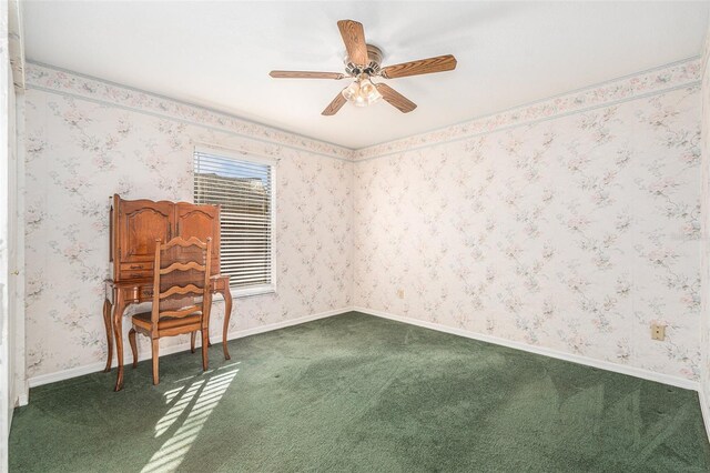 carpeted empty room with wallpapered walls, ceiling fan, and baseboards