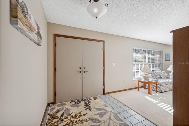 entryway with baseboards and a textured ceiling