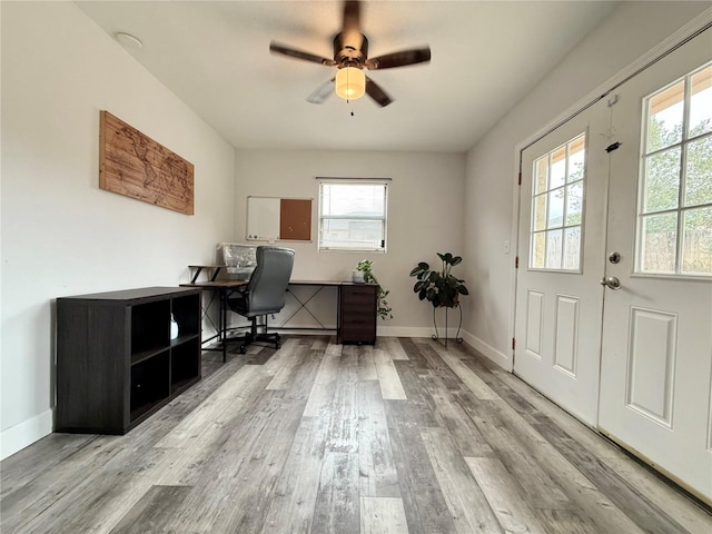 office with baseboards, ceiling fan, and light wood finished floors