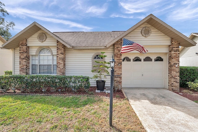 view of front of property featuring a garage and a front lawn