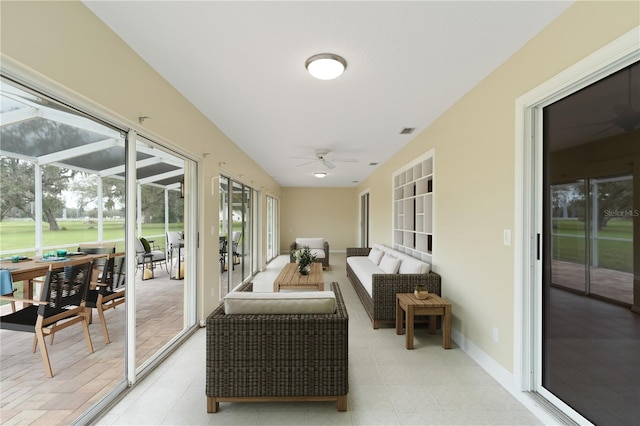 sunroom / solarium featuring visible vents and ceiling fan