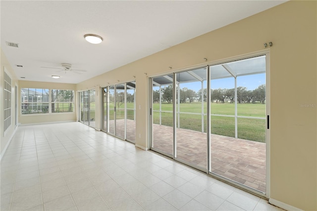 unfurnished sunroom with ceiling fan and visible vents