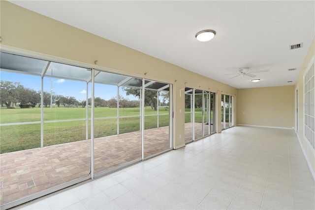 unfurnished sunroom featuring a ceiling fan and visible vents