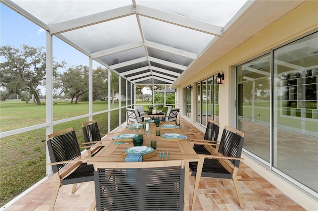 sunroom / solarium featuring a healthy amount of sunlight and lofted ceiling with beams