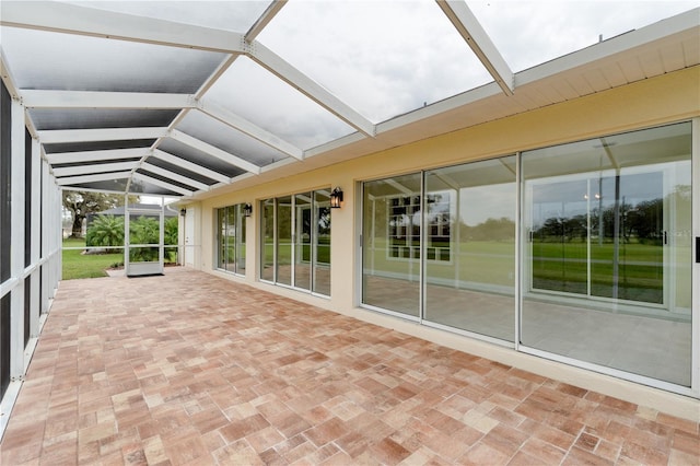 unfurnished sunroom with lofted ceiling with beams