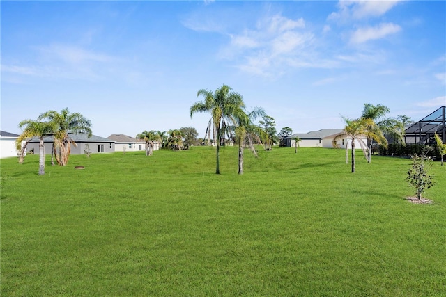 view of yard featuring a residential view and glass enclosure