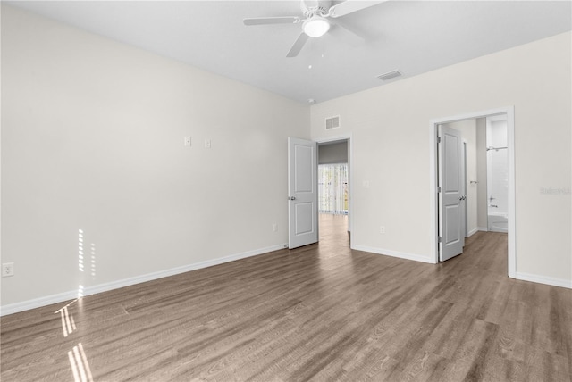 unfurnished bedroom with baseboards, visible vents, and wood finished floors