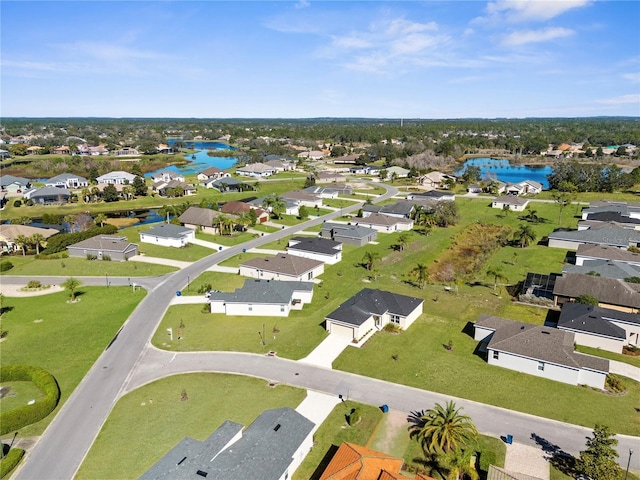 birds eye view of property with a residential view and a water view