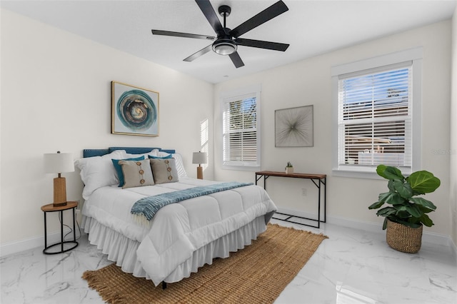 bedroom featuring marble finish floor, ceiling fan, and baseboards