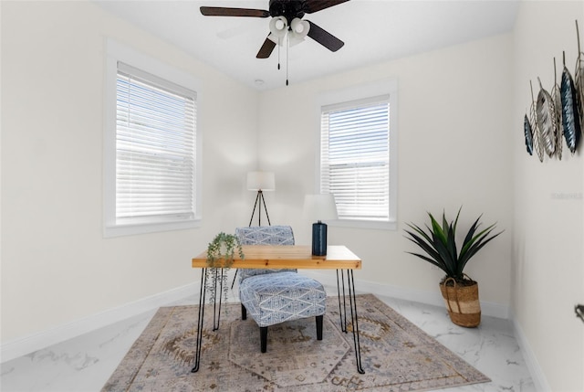 office space featuring ceiling fan, marble finish floor, and baseboards