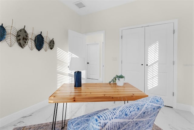 office area with marble finish floor, visible vents, and baseboards