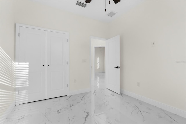 unfurnished bedroom featuring marble finish floor, visible vents, and baseboards