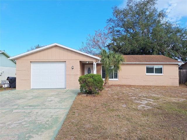 single story home with an attached garage, concrete driveway, and brick siding