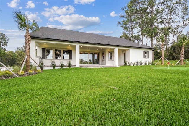 rear view of property with a yard