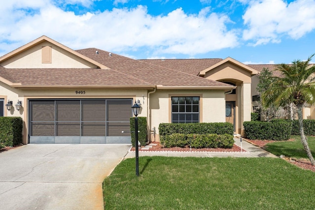 ranch-style house featuring a front lawn and a garage