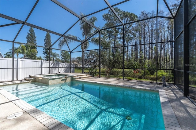 view of swimming pool with a patio area, a lanai, and a pool with connected hot tub