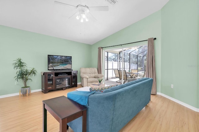 living area with lofted ceiling, visible vents, a ceiling fan, light wood-type flooring, and baseboards