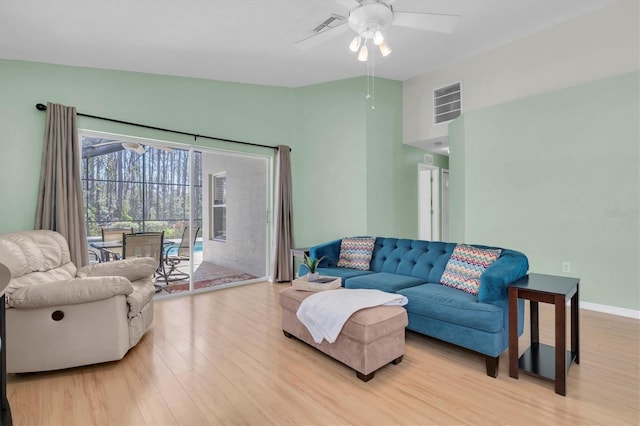 living room with lofted ceiling, ceiling fan, wood finished floors, and visible vents