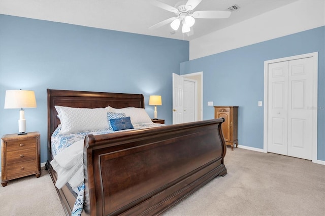 bedroom with light carpet, a closet, visible vents, and baseboards