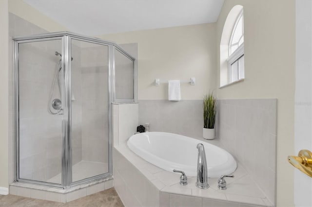 full bath with a garden tub, a shower stall, and tile patterned flooring