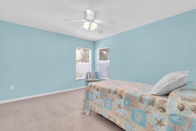 bedroom with ceiling fan, carpet, and baseboards