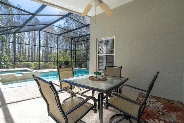 view of patio featuring a ceiling fan, outdoor dining space, a lanai, and a pool with connected hot tub