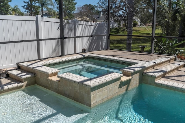 view of swimming pool with an in ground hot tub and a lanai