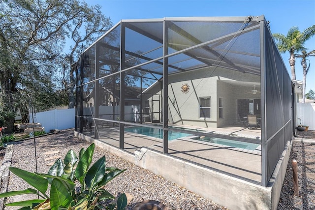 view of swimming pool with a lanai, fence, a ceiling fan, a fenced in pool, and a patio area