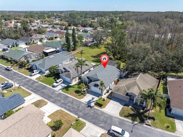 bird's eye view featuring a residential view and a forest view