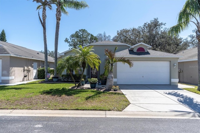 view of front of home with driveway, a front lawn, an attached garage, and stucco siding