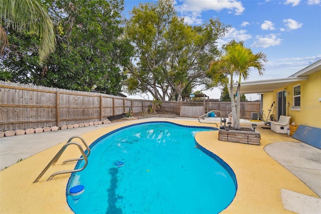 view of swimming pool with a fenced backyard, a fenced in pool, and a patio