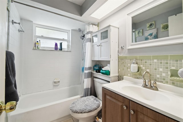 full bathroom featuring toilet, tasteful backsplash, shower / bath combo with shower curtain, and vanity