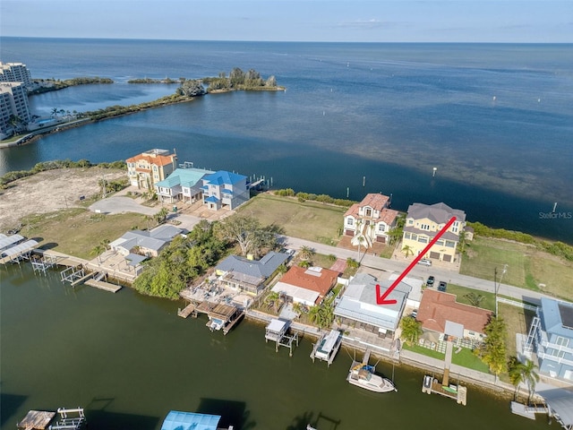 birds eye view of property featuring a water view and a residential view