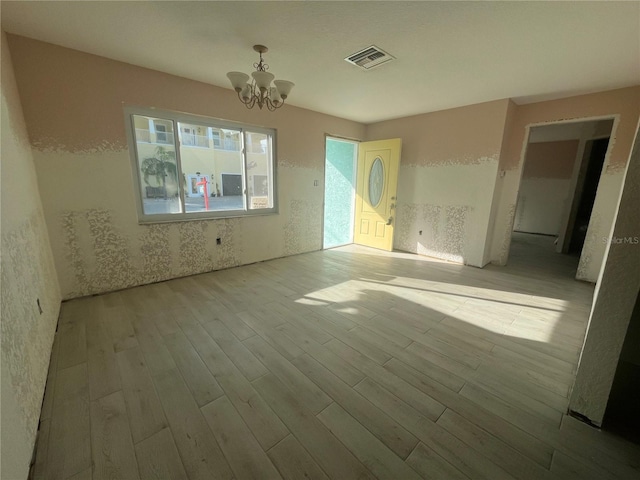 6228 Lonnie Lee Ln, Hudson, FL 34667 - unfurnished living room featuring a chandelier and wood finished floors