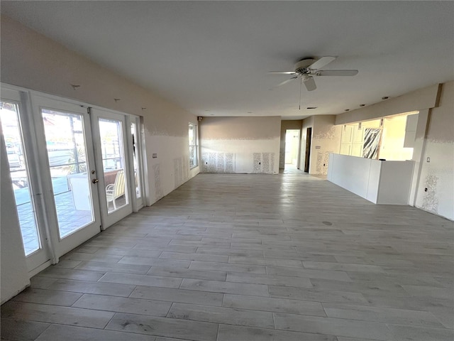 6228 Lonnie Lee Ln, Hudson, FL 34667 - empty room with french doors, plenty of natural light, a ceiling fan, and wood finished floors