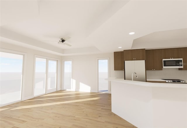 kitchen with recessed lighting, white appliances, a ceiling fan, light countertops, and light wood finished floors