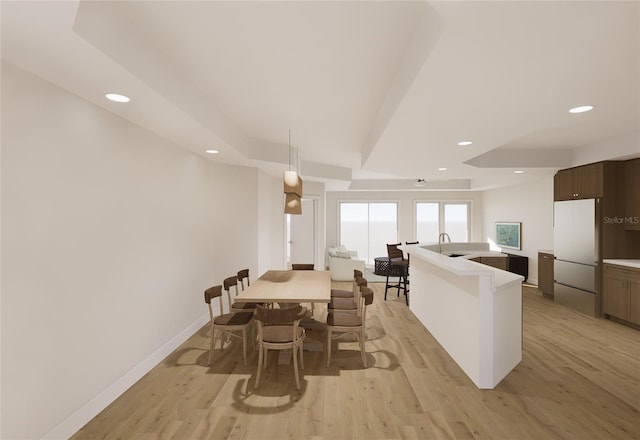 dining area with light wood finished floors, baseboards, and recessed lighting