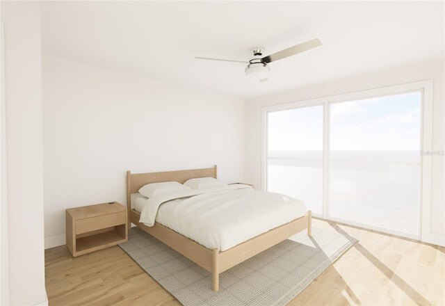 5015 US Highway 19 Unit 401, New Port Richey, FL 34652 - bedroom featuring light wood-style floors, a ceiling fan, and baseboards