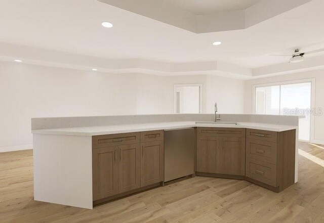 5015 US Highway 19 Unit 401, New Port Richey, FL 34652 - kitchen featuring a sink, light countertops, dishwasher, light wood finished floors, and recessed lighting