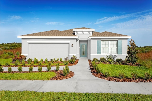 view of front of home featuring a garage, driveway, and stucco siding