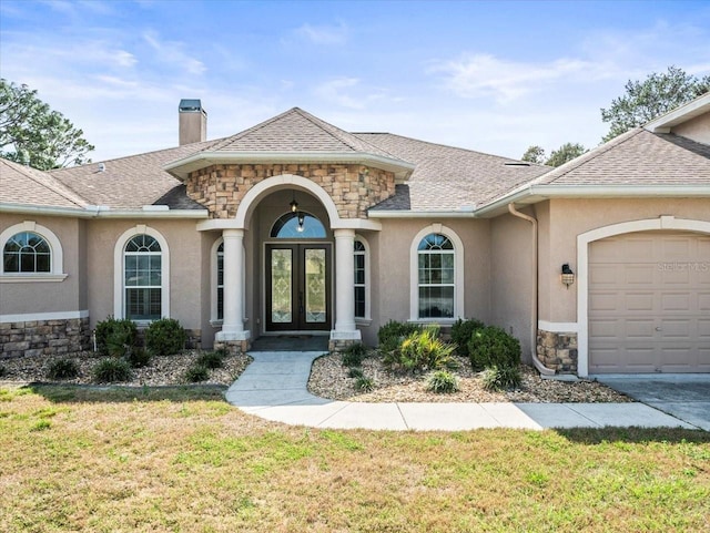 property entrance featuring stone siding, roof with shingles, and stucco siding