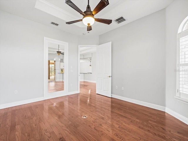 interior space featuring multiple windows, wood finished floors, and visible vents