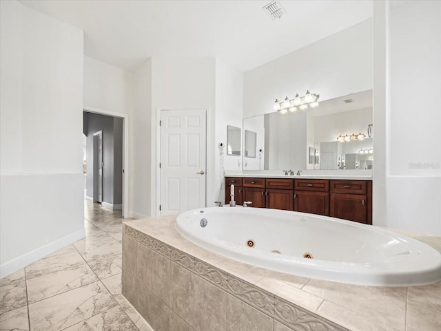 full bath featuring vanity, visible vents, baseboards, marble finish floor, and a whirlpool tub