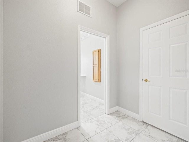 interior space with marble finish floor, baseboards, and visible vents