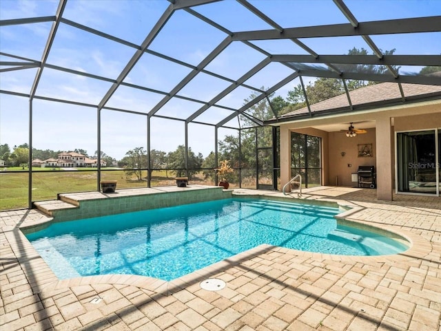 outdoor pool with a lanai, ceiling fan, and a patio