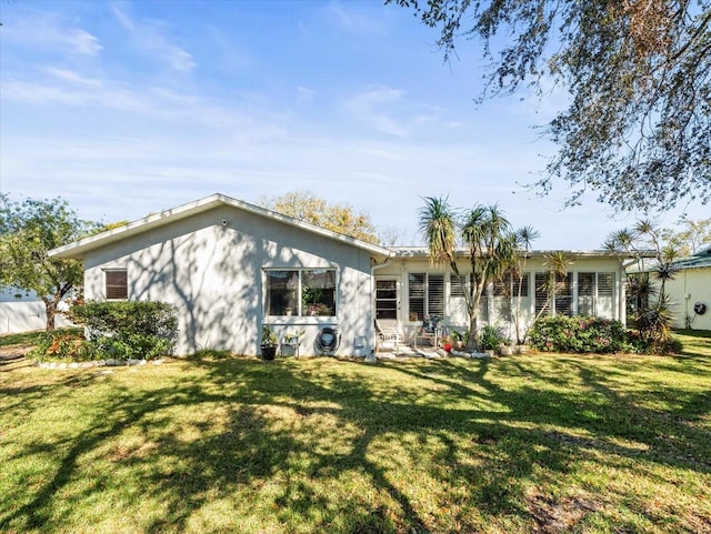 rear view of property with a yard