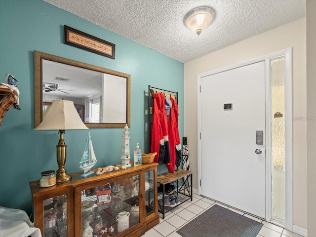 foyer featuring a textured ceiling and light tile patterned flooring