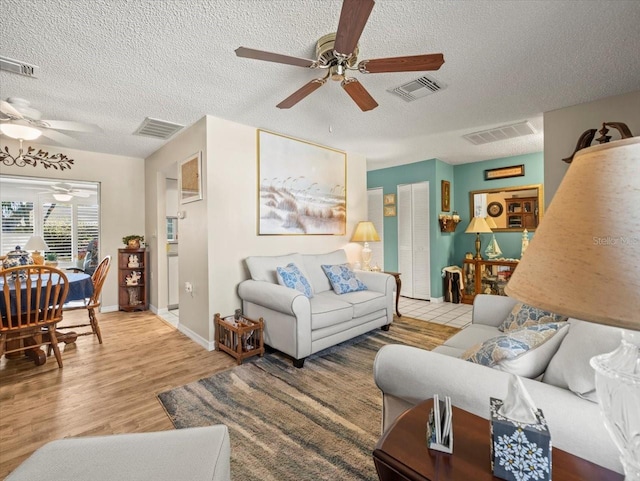 living area featuring light wood-style flooring and visible vents