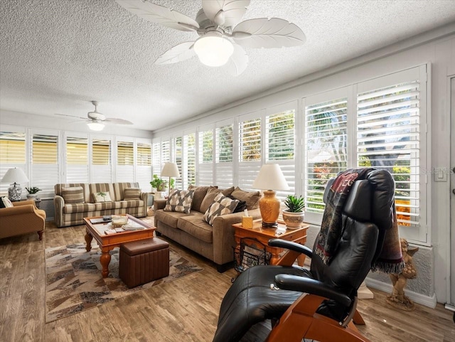 sunroom featuring a ceiling fan